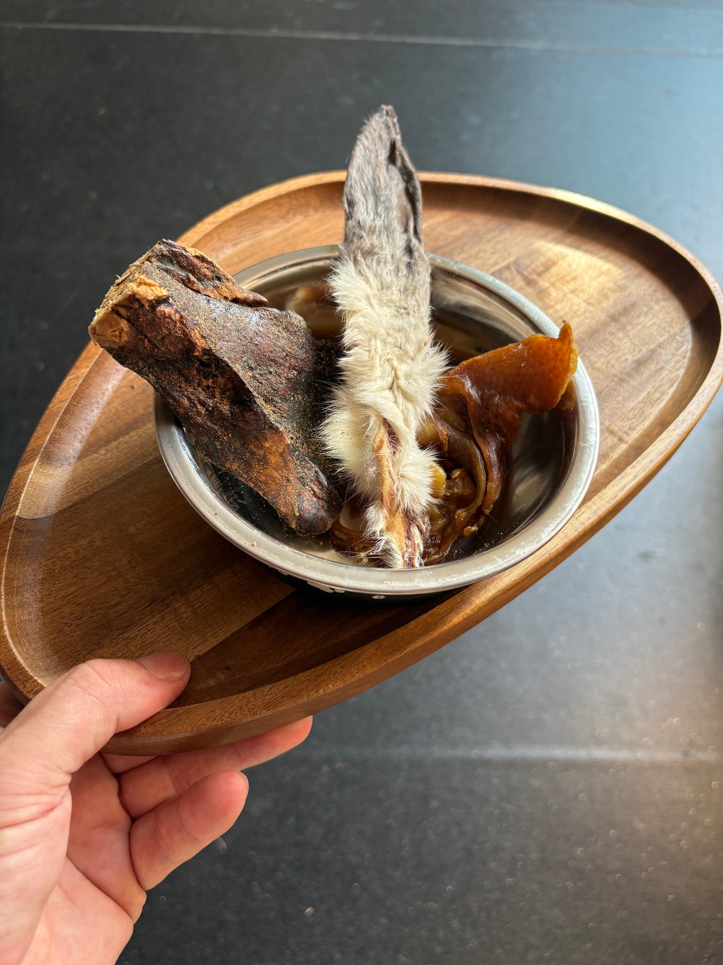 Ted's Natural Trio — rabbit ear, pig ear strip and buffalo steak natural chews served in a bowl on a wooden board
